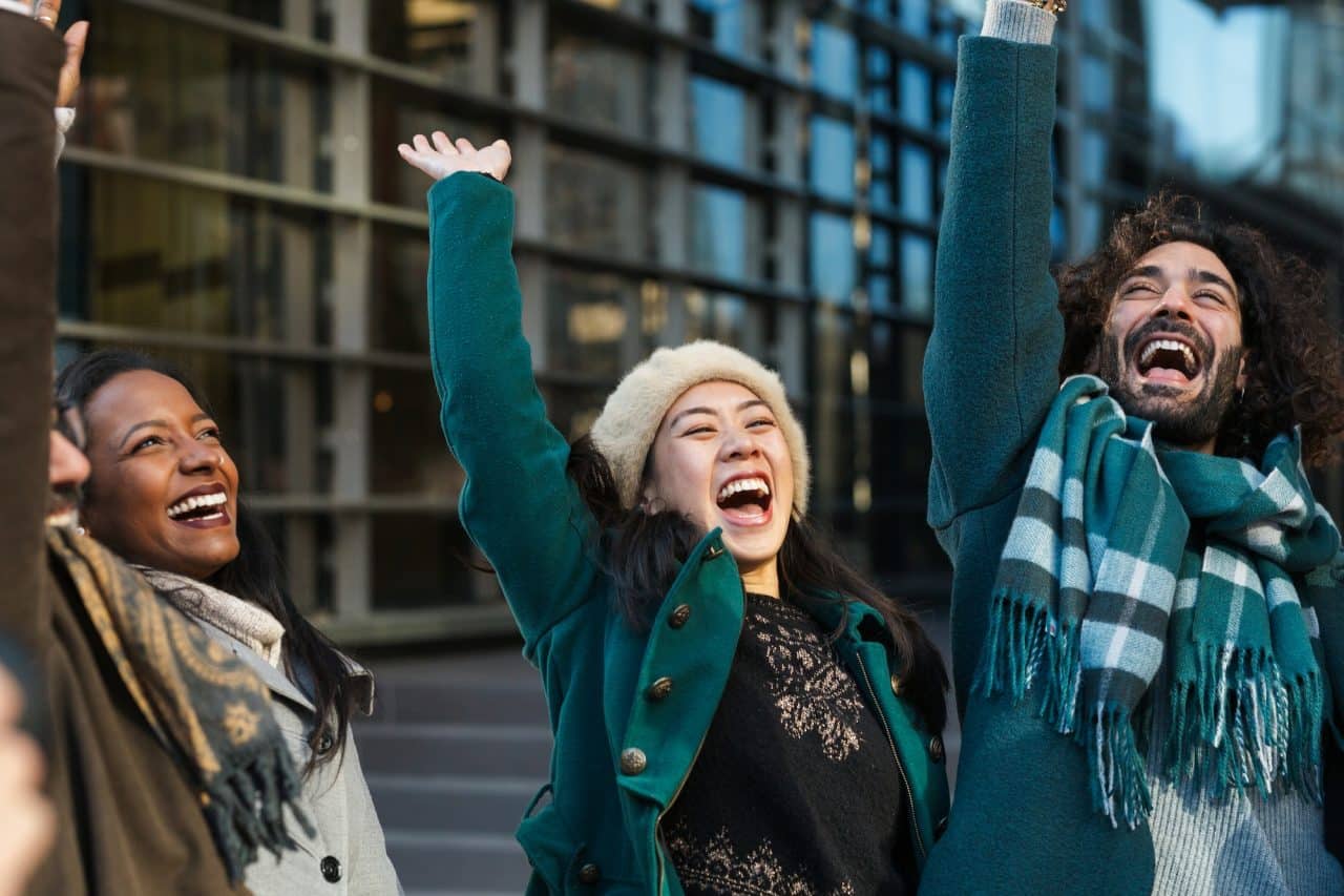 excited-colleagues-celebrating-success-together-with-colleagues-on-city-street.jpg